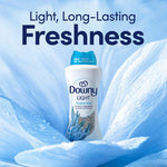 Promotional image of a Downy Light Ocean Mist bottle set against a blue floral-like background with headline "Light, Long-Lasting Freshness"