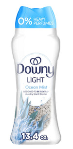 Tall Downy Light Ocean Mist scent booster bottle showing label, translucent window with white scent beads and blue cap