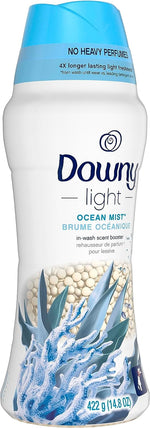 Downy Light Ocean Mist scent booster bottle with blue cap and visible pearl-like scent beads and coral artwork