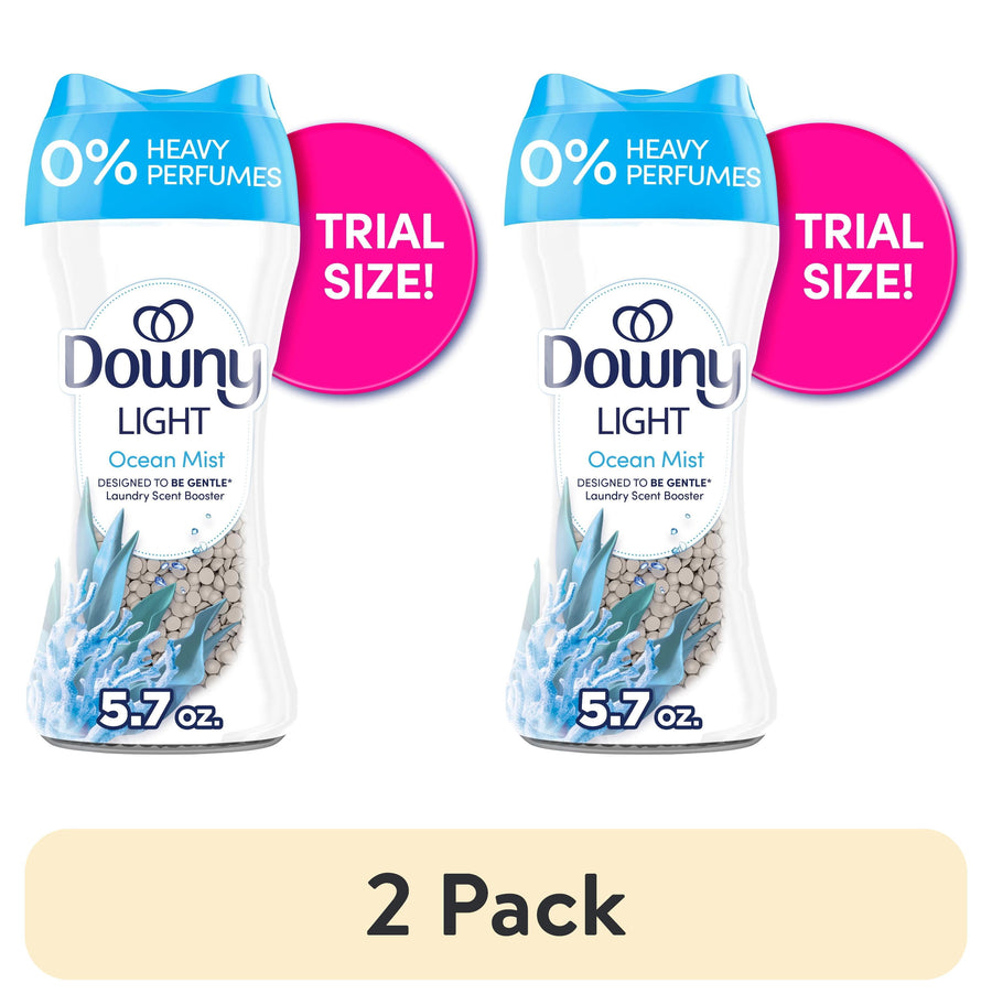 Two Downy Light Ocean Mist scent booster bottles labeled 0% heavy perfumes with pink ‘trial size’ badges and “5.7 oz.” callouts.
