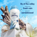 Downy Light Ocean Mist bottle staged with driftwood, shells and scent note text for lily, rain, sandalwood