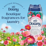 Downy Peonia scent booster bottle surrounded by illustrated pink peonies and meadow graphics