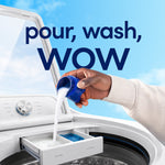Hand pouring liquid fabric softener from a blue cap into a washer dispenser with copy 'pour, wash, WOW'