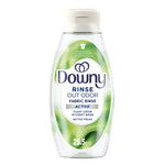 Clear bottle of Downy Rinse Out Odor fabric rinse with green label and white cap on a white background