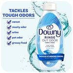Bottle of Downy Rinse Out Odor fabric rinse in ocean mist scent with water splash and odor checklist.