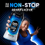 Person holding a Downy Unstopables Odor Defense Daybreak + Clean bottle against a radiating blue background with non-stop odoreblocker text