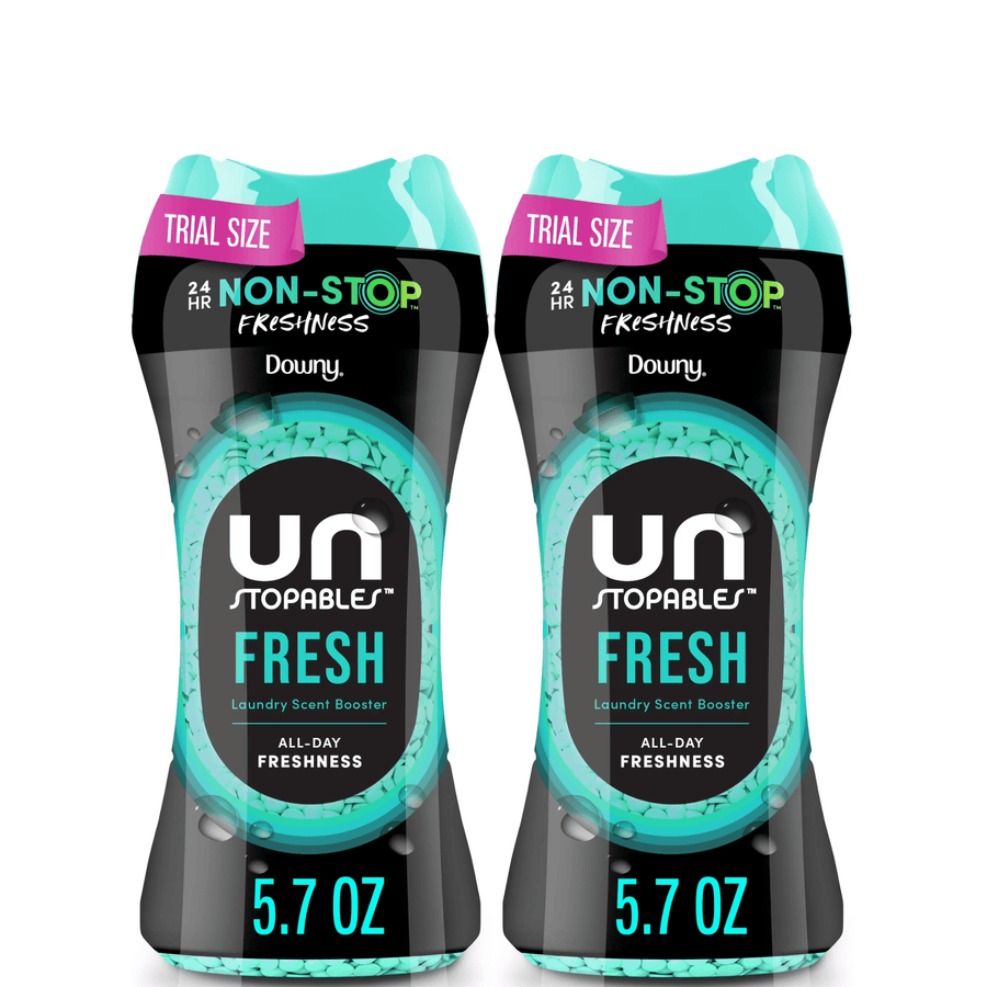 Two trial-size Downy Unstopables Fresh laundry scent booster bottles shown side by side with teal accents and 5.7 oz label