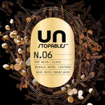 Close-up gold label reading UNSTOPABLES N.06 with listed top, middle and base notes over a clove background.