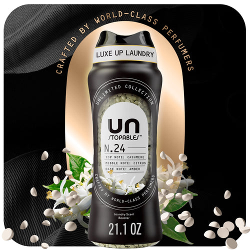 Black Downy Unstopables N.24 scent booster bottle with visible white scent beads and floral accents on a dark luxe background