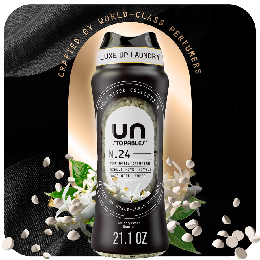 Black Downy Unstopables N.24 scent booster bottle with visible white scent beads and floral accents on a dark luxe background