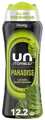 Tall black bottle of Downy Unstopables Paradise laundry scent booster with green accents and tropical leaf graphics
