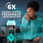 Lifestyle ad showing a smiling woman sniffing a teal sweater with a Downy Unstopables Fresh bottle and text about longer-lasting freshness.