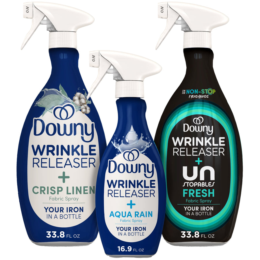 Three Downy Wrinkle Releaser fabric spray bottles - crisp linen, aqua rain and fresh variants