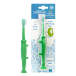 Dr. Brown's green crocodile toddler toothbrush shown loose beside its blister-pack backing with product graphics and blue bubble design.