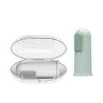 Open clear storage case with a gray silicone finger toothbrush inside and a light green brush standing beside it