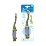 Dr. Brown's toddler toothbrush with green dinosaur design shown next to its blister card packaging
