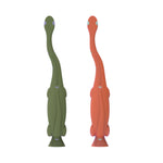 Back view of two dinosaur-shaped Dr. Brown's toddler toothbrush handles showing textured grips and suction bases.