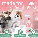 Dreft spray bottle beside a basket of folded laundry with plant-based and hypoallergenic icons