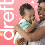 Smiling mother holding a happy baby on a pink background with large ‘dreft’ branding running vertically at left.