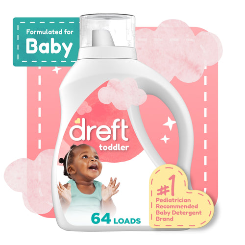 White Dreft toddler detergent bottle graphic with a smiling baby illustration and pink background accents.
