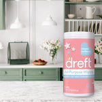 Dreft All Purpose Wipes tub placed on a marble countertop with a softly styled kitchen scene in the background