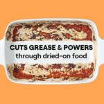 Baked casserole dish with dried-on food residue and bold text 'CUTS GREASE & POWERS through dried-on food' across the center