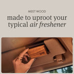 Hand attaching a Drift teak wood car freshener to a vehicle sun visor with headline text about replacing typical air fresheners