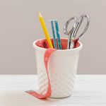 Dritz ceramic thimble container used as desk holder with scissors, pencil, ruler and measuring tape inside