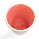 Top-down view into coral-glazed interior of a Dritz ceramic thimble container showing embossed Dritz logo