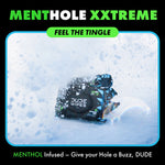 DUDE Wipes MentHole XXtreme pack half-buried in snow with stylized snow effect and green headline text above.