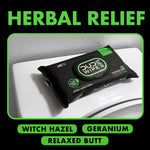 Single DUDE Wipes herbal relief pack placed on a closed toilet lid; 'HERBAL RELIEF' headline above and scent names below.