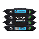 Stacked four-pack of DUDE Wipes XL flushable wipes in black packaging with barcode panel visible on front