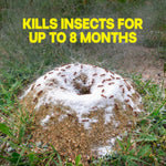 Ant mound covered with white dust in grassy ground with overlaid yellow text stating kills insects for up to 8 months.