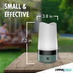 DynaShield moss green device on a wood surface with overlaid dimensions 7.3 in height and 3.8 in width, outdoor background