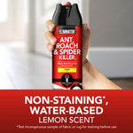 Hand holding a red Eliminator spray can in a blurred indoor setting with text noting non-staining water-based lemon scent