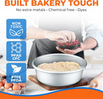 Anodized round pan filled with dough on a board while hands sprinkle fruit, overlaid with non-toxic and PTFE/PFOA icons