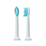 Two white Equate electric replacement brush heads shown front and side to display bristle profile and neck shape