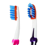 Close-up of two Equate toothbrush heads showing blue bristles and orange flexible trim.
