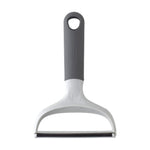 Close-up studio photo of Evercare DUO lint and pet hair remover showing gray handle and horizontal blade edge