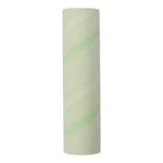 Close-up of a pale green patterned adhesive lint roller refill roll shown standing vertically