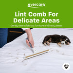 Hand using Evercare lint comb on a white bed surface with pet hair and a small sleeping puppy nearby
