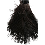 Detailed close-up of dark ostrich feathers fanning from the central quill beneath a black ferrule
