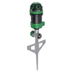 Angled view of a green and black spike gear-drive lawn sprinkler with metal stake