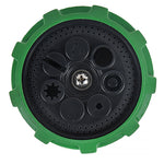 Close-up of green-rimmed circular spray plate showing multiple nozzle pattern openings