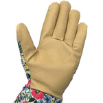 Full palm-facing gardening glove in tan leather with floral fabric trim and cuff