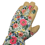 Top view of a floral-patterned gardening glove with tan leather reinforcements on fingers