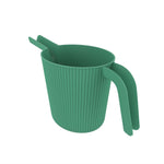 Angled view of green ribbed watering can showing interior and dual-section handle from above on white background.