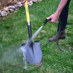 Lifestyle image of a person using an Expert Gardener hose nozzle to spray and clean a shovel on grass