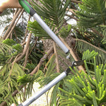 Expert Gardener lopper cutting a branch among tree foliage, showing handles and blade in use