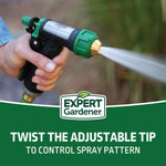 Hand-held Expert Gardener green-and-black adjustable spray nozzle in use, spraying a focused water stream with brand logo and instructional text overlay
